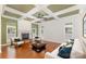 Bright living room with a fireplace, coffered ceiling, hardwood floors, and lots of natural light at 6729 Garden Hill Dr, Huntersville, NC 28078