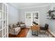 Well-lit home office featuring hardwood floors, built-in shelves, and ample workspace at 6729 Garden Hill Dr, Huntersville, NC 28078