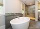 Bright bathroom featuring dual sinks, granite countertops and a luxurious free-standing tub at 7324 Leharne Dr, Charlotte, NC 28270