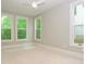 Sunlit bedroom with neutral carpet, trim and paint and three windows creating a refreshing space at 7324 Leharne Dr, Charlotte, NC 28270