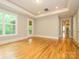 Spacious bedroom featuring hardwood floors, recessed lighting and access to a private balcony at 7324 Leharne Dr, Charlotte, NC 28270