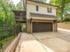 Rear home exterior view featuring an attached two-car garage and outdoor porch at 7324 Leharne Dr, Charlotte, NC 28270