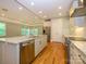 Open concept kitchen with stainless steel appliances, granite countertops, and hardwood flooring at 7324 Leharne Dr, Charlotte, NC 28270