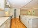 Bright kitchen with stainless appliances, granite counters, and hardwood floors opening to living area at 7324 Leharne Dr, Charlotte, NC 28270