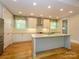 Modern kitchen featuring granite countertops, stainless steel appliances, and a large center island at 7324 Leharne Dr, Charlotte, NC 28270