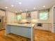 Well-lit kitchen with a center island, stainless steel appliances, and ample counter space at 7324 Leharne Dr, Charlotte, NC 28270