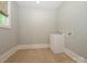 Functional laundry room with a utility sink and tile flooring, offering practicality at 7324 Leharne Dr, Charlotte, NC 28270