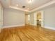 Expansive room with hardwood floors, recessed lighting, and entry to an adjacent space at 7324 Leharne Dr, Charlotte, NC 28270