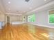 Expansive living room with hardwood floors, recessed lighting, and scenic views from large windows at 7324 Leharne Dr, Charlotte, NC 28270