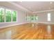 Spacious living room featuring hardwood floors, recessed lighting, and large windows for natural light at 7324 Leharne Dr, Charlotte, NC 28270