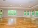 Spacious living room with hardwood floors, recessed lighting, and large windows offering natural light at 7324 Leharne Dr, Charlotte, NC 28270