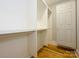 Organized walk-in closet with custom shelving and ample storage space, plus hardwood floors at 7324 Leharne Dr, Charlotte, NC 28270