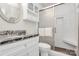 Updated bathroom with granite vanity, white cabinets, and shower with glass door at 9232 Four Mile Creek Rd, Charlotte, NC 28277