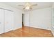Light-filled bedroom with hardwood floors, closet, and neutral paint at 9232 Four Mile Creek Rd, Charlotte, NC 28277
