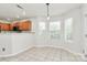 Sunlit breakfast area with tile floors, windows, and access to the kitchen at 9232 Four Mile Creek Rd, Charlotte, NC 28277