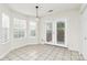 Bright breakfast area featuring tile floors, windows with blinds and glass panel back door at 9232 Four Mile Creek Rd, Charlotte, NC 28277