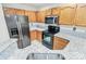 Modern kitchen featuring granite counters, wooden cabinets, and black appliances at 9232 Four Mile Creek Rd, Charlotte, NC 28277
