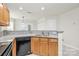 Updated kitchen with granite countertops and stainless steel dishwasher with oak cabinets at 9232 Four Mile Creek Rd, Charlotte, NC 28277