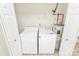 Laundry area featuring a washer, dryer, and storage shelving at 9232 Four Mile Creek Rd, Charlotte, NC 28277