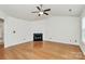 Cozy living area featuring a fireplace, ceiling fan and plenty of natural light at 9232 Four Mile Creek Rd, Charlotte, NC 28277