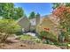 Expansive back of house featuring stone patio, gas grill, and manicured flowerbeds at 9526 Greyson Ridge Dr, Charlotte, NC 28277