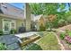 Back of the house showing a patio, manicured lawn, and decorative flower beds at 9526 Greyson Ridge Dr, Charlotte, NC 28277