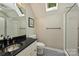 Bathroom features black granite countertop, modern sink, and walk-in shower with glass door at 9526 Greyson Ridge Dr, Charlotte, NC 28277
