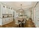 Elegant dining room features a wood table, chairs, modern chandelier, and built-in cabinets at 9526 Greyson Ridge Dr, Charlotte, NC 28277