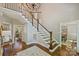 Spacious foyer featuring a staircase, hardwood floors, chandelier, and views into the dining room at 9526 Greyson Ridge Dr, Charlotte, NC 28277