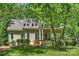 Charming home with a classic design, featuring a covered front porch and mature trees providing shade at 9526 Greyson Ridge Dr, Charlotte, NC 28277