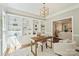 Bright home office with built-in bookshelves, a desk, and comfortable seating, open to the living room at 9526 Greyson Ridge Dr, Charlotte, NC 28277