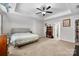 Spacious bedroom with a ceiling fan, tray ceiling, carpeted floors, and ample closet space at 1004 Craven St, Indian Trail, NC 28079