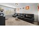 A bonus room featuring an oversized leather couch and natural light through the window at 1004 Craven St, Indian Trail, NC 28079