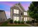 Charming two-story home featuring stone accents, covered front porch, and manicured landscaping at 1004 Craven St, Indian Trail, NC 28079