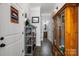 Hallway with tile flooring, cabinet, and bathroom offers functional space and access to other areas at 1004 Craven St, Indian Trail, NC 28079