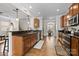 Spacious kitchen featuring dark granite countertops, wood cabinetry, and a view of the adjacent dining area at 1004 Craven St, Indian Trail, NC 28079