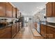 Open-concept kitchen with dark wood cabinets, granite counters, stainless appliances and tile floors at 1004 Craven St, Indian Trail, NC 28079