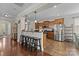 Modern kitchen with a breakfast bar, stainless steel appliances, and a seamless flow into the living area at 1004 Craven St, Indian Trail, NC 28079