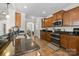 Well-equipped kitchen boasting dark granite countertops, stainless steel appliances, and tiled flooring at 1004 Craven St, Indian Trail, NC 28079