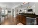 Well-lit kitchen with a breakfast bar, granite countertops, stainless steel appliances, and a view to the breakfast area at 1004 Craven St, Indian Trail, NC 28079