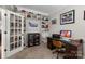 Home office with dark wood desk and a custom bookcase showcasing an extensive sports memorabilia collection at 1004 Craven St, Indian Trail, NC 28079