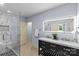 A modern bathroom with double sinks, sleek vanity, and glass enclosed shower at 1009 Seminole Dr, Waxhaw, NC 28173