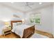 Cozy bedroom featuring a wooden bed frame, hardwood floors, a white rug, and natural light from the window at 1009 Seminole Dr, Waxhaw, NC 28173