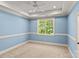 Light-filled bedroom with large window, neutral carpet, and classic trim details at 1009 Seminole Dr, Waxhaw, NC 28173