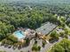 Aerial view of a community pool and tennis courts, highlighting the recreational amenities available to residents at 1009 Seminole Dr, Waxhaw, NC 28173