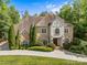 Stunning two-story brick home with manicured landscaping and a circular driveway, exuding curb appeal at 1009 Seminole Dr, Waxhaw, NC 28173