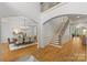 Grand foyer with staircase, hardwood floors and arched entryways to dining and living spaces at 1009 Seminole Dr, Waxhaw, NC 28173