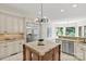 Open kitchen features stainless steel appliances, granite countertops, an island, and a breakfast nook with large windows at 1009 Seminole Dr, Waxhaw, NC 28173
