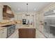 Bright kitchen boasts stainless steel appliances, a gas cooktop, granite countertops, a large island, and ample cabinets at 1009 Seminole Dr, Waxhaw, NC 28173