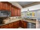 A kitchen featuring granite countertops, stainless steel appliances, and wooden cabinetry at 1009 Seminole Dr, Waxhaw, NC 28173